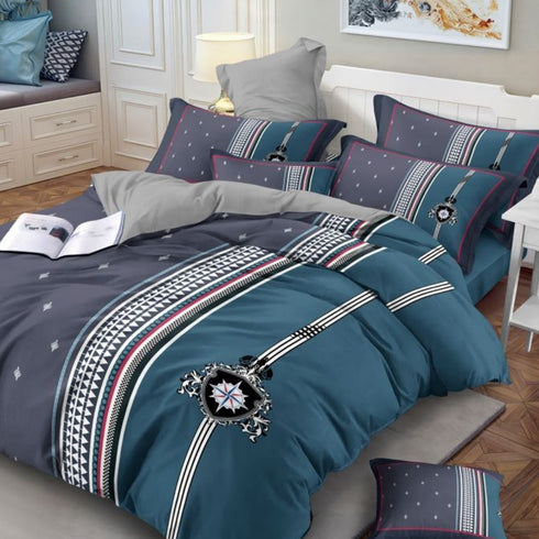 A king size bed sheet set with pillow covers displayed on a bed, featuring a geometric pattern with blue, gray, and white colors.