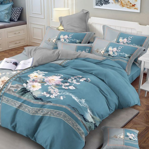 A set of king-size bed sheets with floral print, including a bedsheet and two pillow covers, displayed on a bed in a room with decorative pillows and a book.