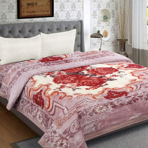 Bed with floral comforter in a bedroom setting