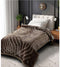Brown textured blanket on a bed in a bedroom setting
