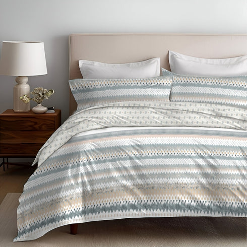 A 4 piece bedding set displayed on a bed, with a comforter, bedsheet, and two pillow covers, in a room setting.