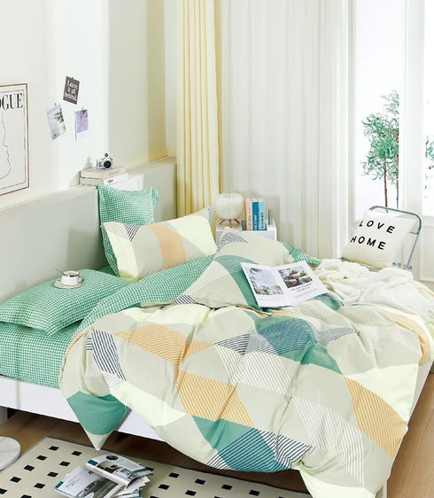 A king size bed sheet set with pillow covers displayed in a bedroom setting, featuring a geometric pattern in green, beige, and white colors.