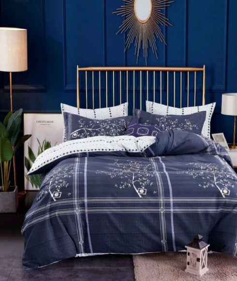 A top sheet with a floral pattern on a single bed in a bedroom setting, complemented by a nightstand, lamp, and decorative wall element.