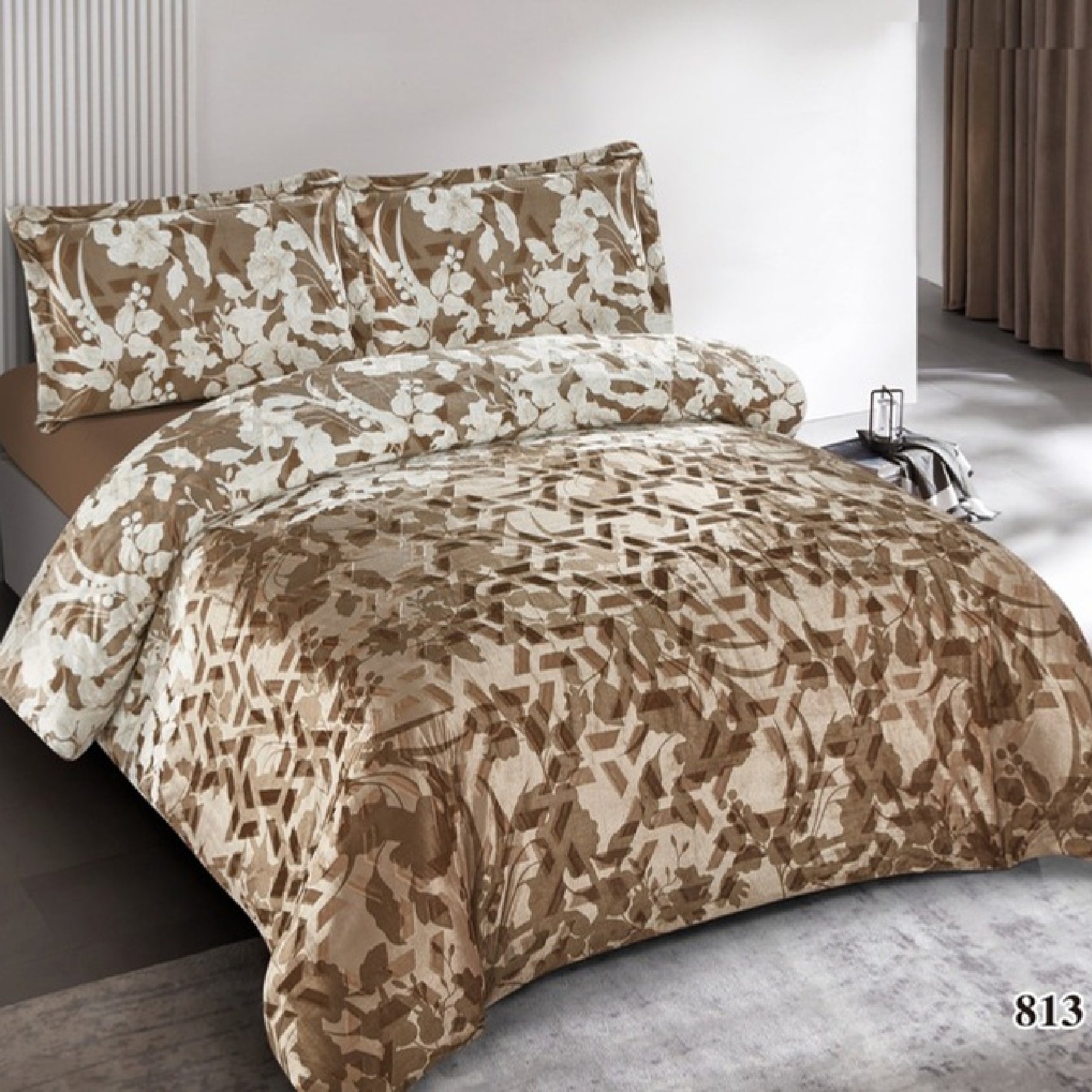 Brown and beige floral patterned comforter set on a bed in a bedroom.
