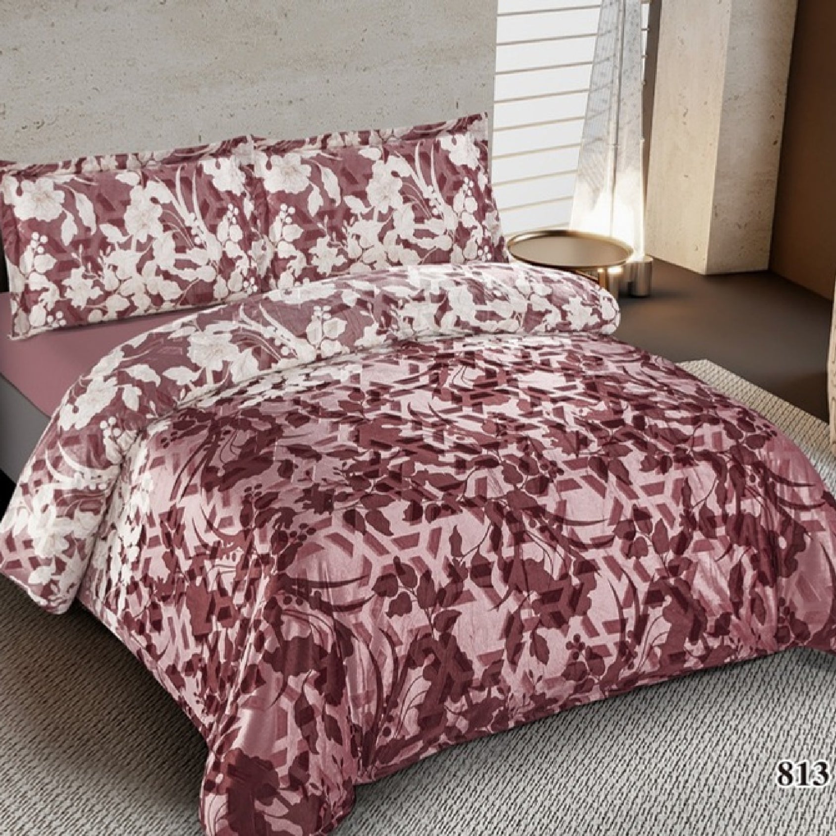 Floral patterned bedding set on a bed in a room with a window.
