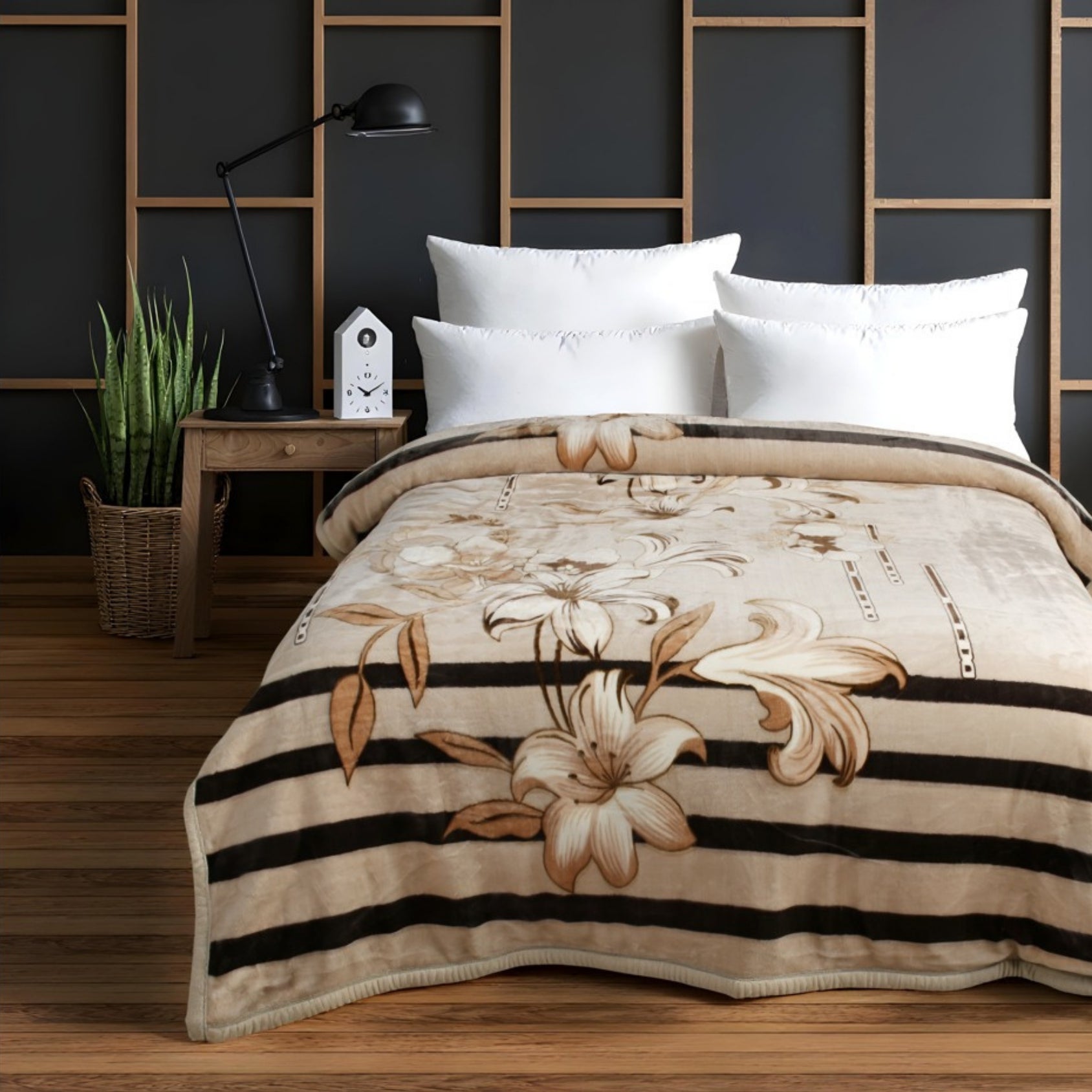 Beige floral patterned blanket on a bed in a bedroom setting with a dark wall and wooden nightstand.